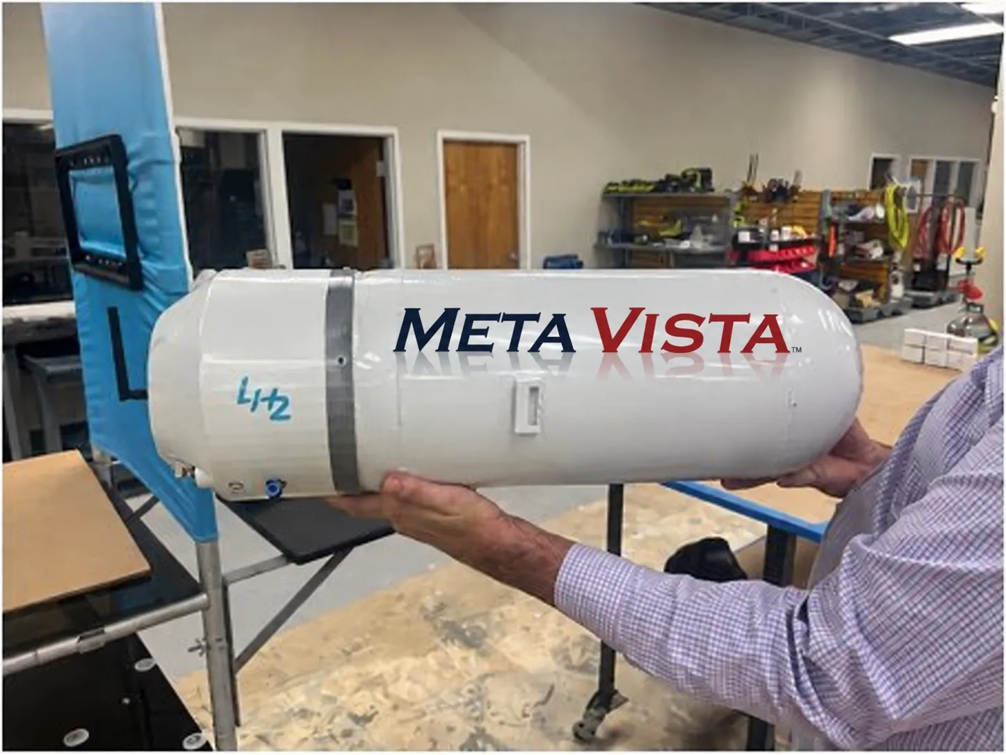 A MetaVista-branded liquid-hydrogen tank prototype held in a workshop